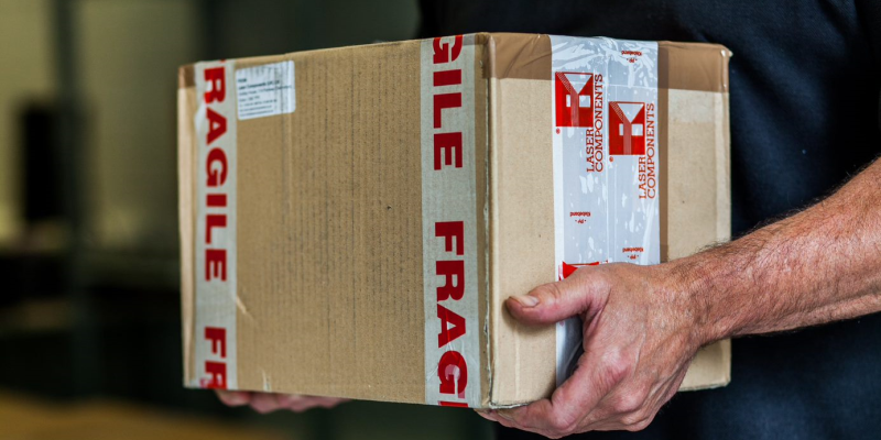 image of a person carrying a large box