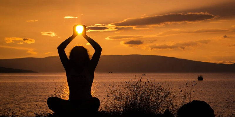 yoga by a lake at sunset