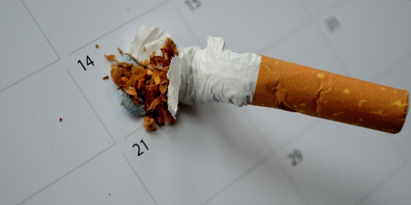 Image of cigarette being put out on a calendar