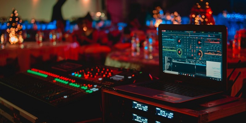 Image of a sound deck and computer lit up.